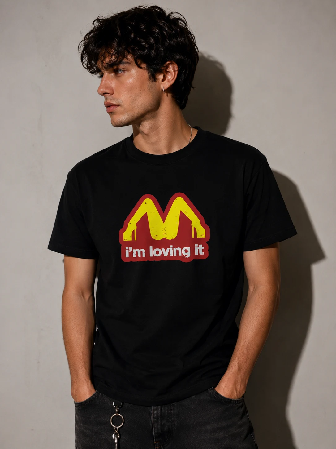 Model in a black tee with golden arch lettering