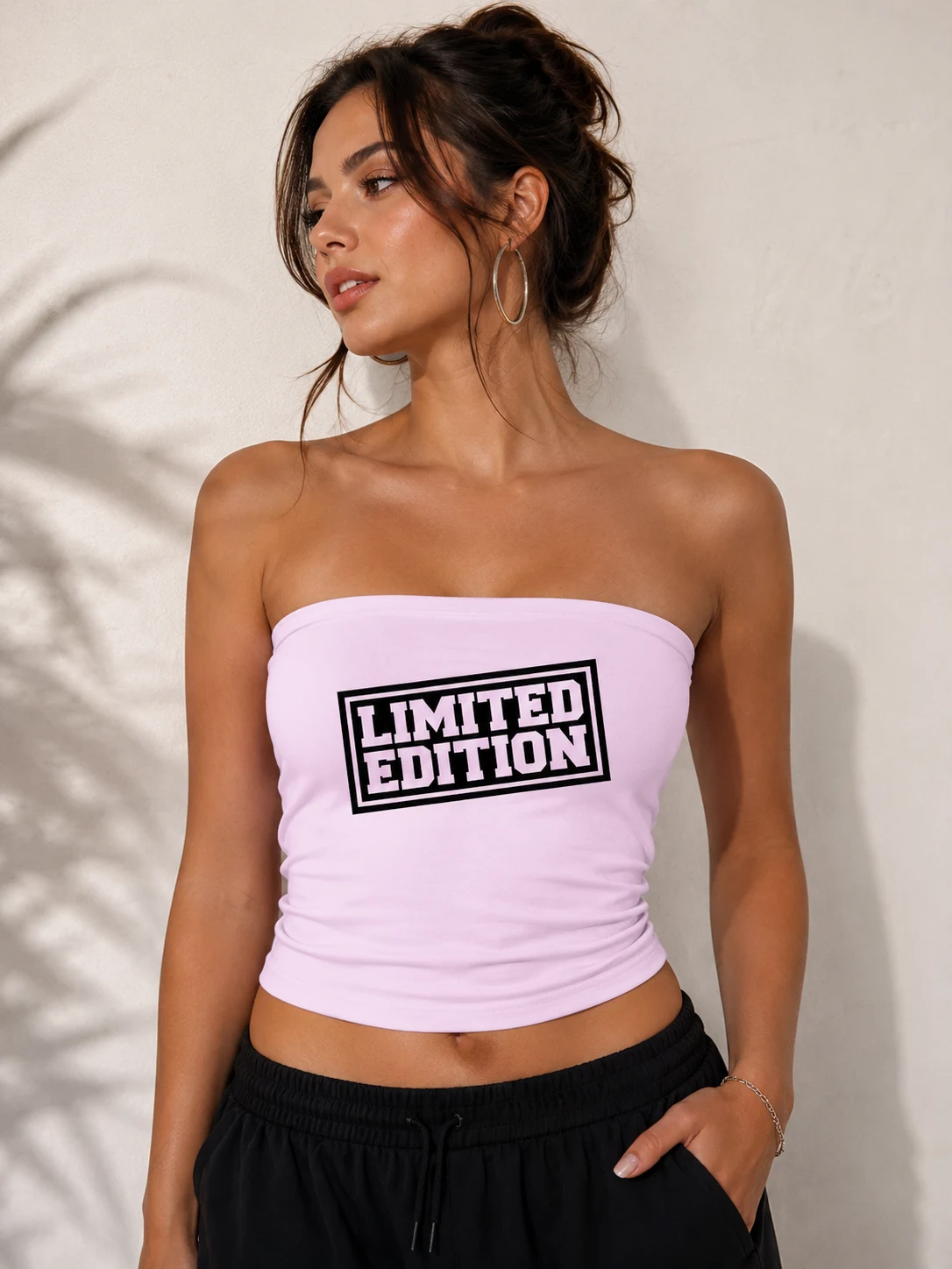 Model in a white tube top with a boxed limited edition label print