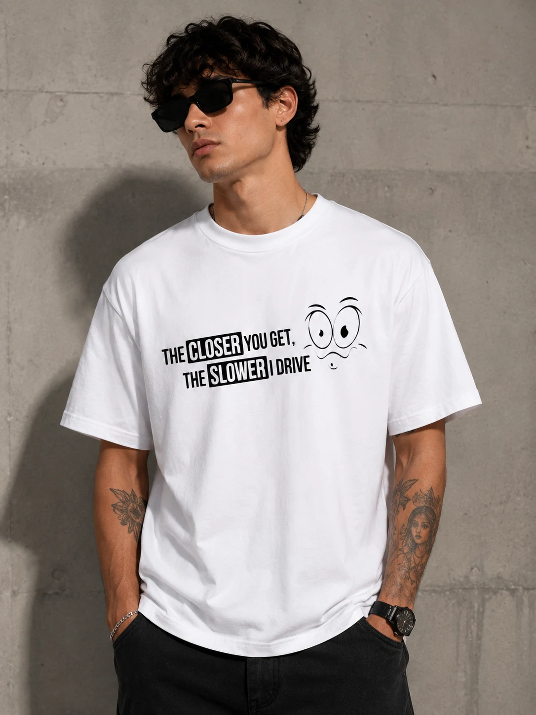 Model in a white tee reading the closer you get, the slower I drive